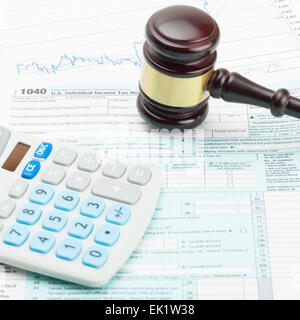 Judge's gavel and calculator over US 1040 Tax Form - close up shot Stock Photo