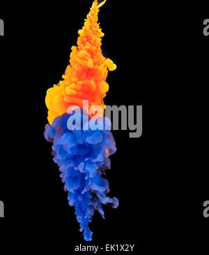 colorful ink creating smoke patterns in water Stock Photo