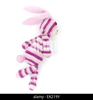 Knitted rabbit toy is running fast, closeup photo isolated on white background Stock Photo