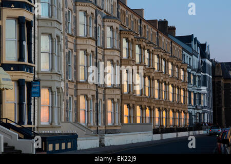 Ceredigion, Wales, UK. 04th Apr, 2015. UK Weather: Aberystwyth, Wales, Sunset reflected in the windows of buildings on the promenade. Credit:  Dave Stevenson/Alamy Live News Stock Photo