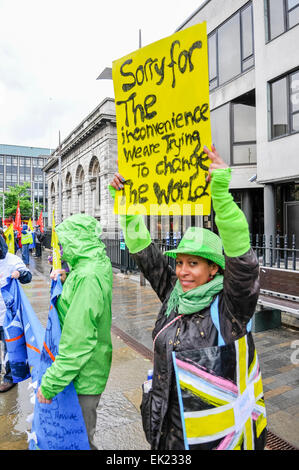 Belfast, Northern Ireland. 15th June 2013. A woman holds up a banner which says 'Sorry for the inconvenience. We are trying to change the World' at an anti-G8 protest organised by the Irish Congress of Trade Unions (ICTU) Stock Photo