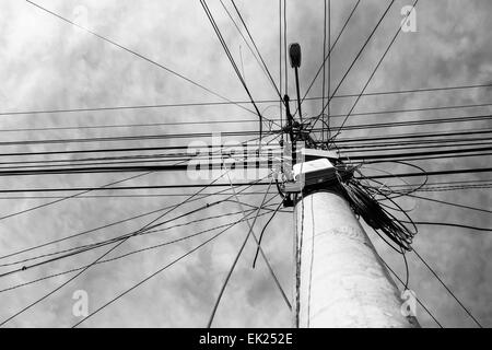 A street lamp post with many electrical cables that run in different directions. Stock Photo