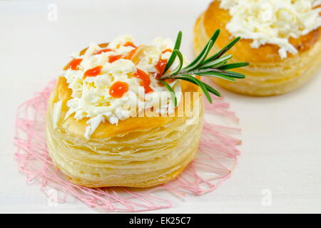 Homemade pastry with cheese on the white table with rosemary Stock Photo