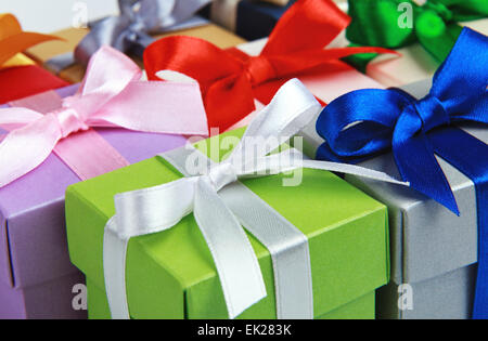 Colorful gift wrapping bows and silver sequins on white festive