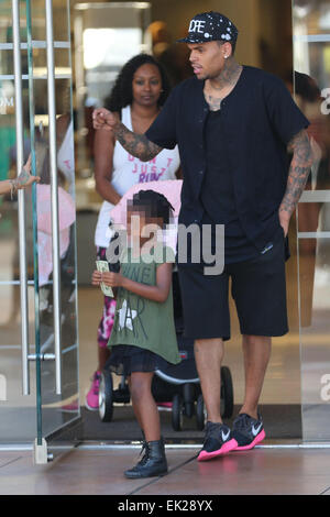 Chris Brown seen with girlfriend Karrueche Tran and friends at The Grove. They lunched at La Piazza Ristorante then headed for Nordstrom's to shop before returning to Valet before leaving. Featuring: Chris Brown,Karrueche Tran Where: Los Angeles, Californ Stock Photo