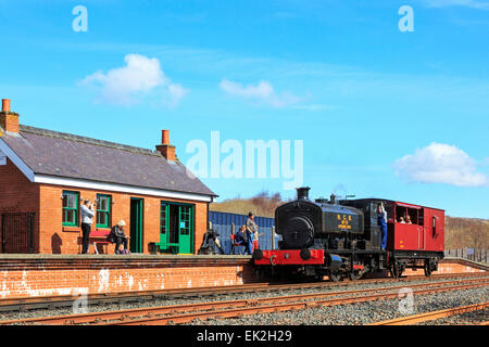 Fireless coal driven locomotive pulling a brake van carrying tourists at Dunaskin Industrial Railway museum, Ayrshire, Scotland Stock Photo