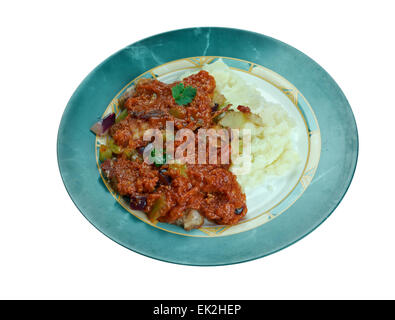 New Orleans Grillades and Grits -  medallions of various meats, conventionally beef, veal and pork. breakfast or brunch over gri Stock Photo