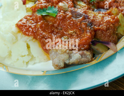 New Orleans Grillades and Grits -  medallions of various meats, conventionally beef, veal and pork. breakfast or brunch over gri Stock Photo