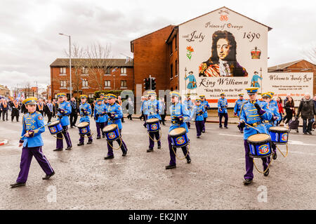 Belfast, Northern Ireland. 1st March 2014 - A flute band marches past the mural at Sandy Row Stock Photo