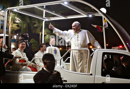 Pope Francis gives a thumbs up from the popemobile on arrival at the Villamor Airbase January 15, 2015 in Pasay City, The Philippines. Stock Photo