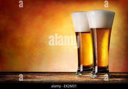 Two glasses of beer on a yellow background Stock Photo
