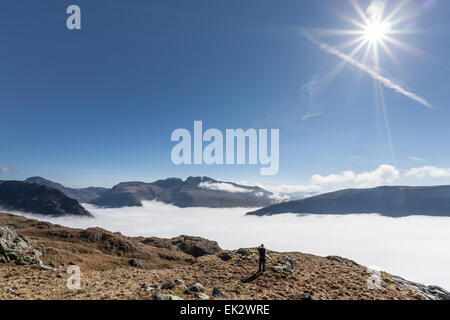Cloud inversion over Wastwater looking towards Yewbarrow, Scafell Pike, Scafell and Wastwater Screes from Middle Fell sunburst Stock Photo