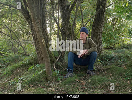 Man sitting under the trees Stock Photo