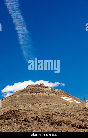 Jet contrails against clear blue sky above Tenderfoot, or S, Mountain, Salida, Colorado, USA Stock Photo