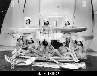 Chorus Girls with Large Spoon, Fork & Knife, on-set of the Film 'Merry-Go-Round of 1938', 1937 Stock Photo