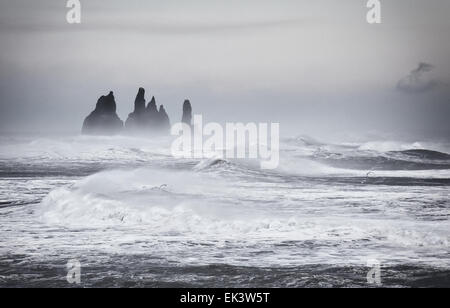 Giant waves and rough seas along the south coast of Iceland, batter the sea stacks near Vik. Stock Photo