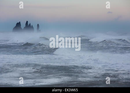 Giant waves and rough seas along the south coast of Iceland, batter the sea stacks near Vik. Stock Photo