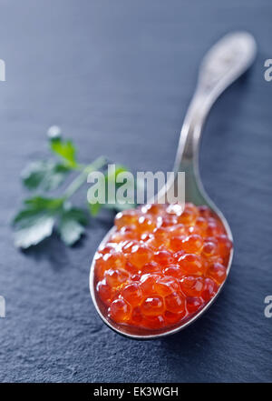 red salmon caviar in the metal spoon Stock Photo