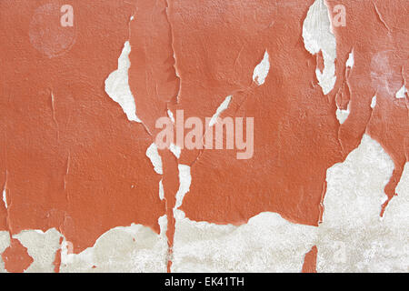 Peeling red wall, detail of an abandoned and crumbling wall Stock Photo