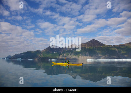 Kayaking in Bear Glacier Lagoon, Kenai Fjords National Park, near Seward, Alaska.  (model released) Stock Photo