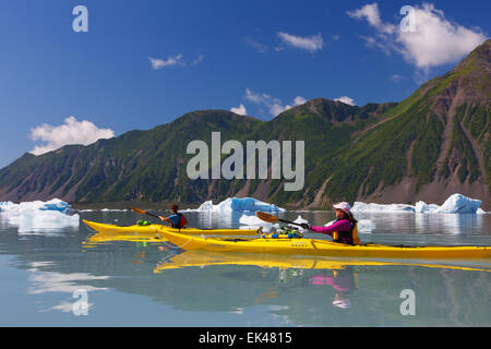 Kayaking in Bear Glacier Lagoon, Kenai Fjords National Park, near Seward, Alaska.  (model released) Stock Photo