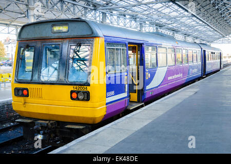 Railbus style "Pacer" diesel multiple unit train operated by Northern Rail, waiting at a railway station platform; old DMU; public transport UK; Stock Photo