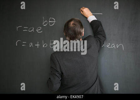 Mathematics teacher at the blackboard Stock Photo