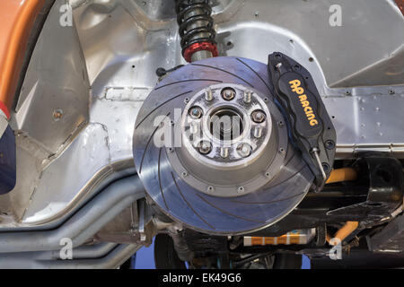 Car brake disc and caliper on a vehicle modified for motor sport. Stock Photo