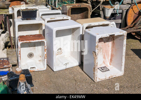 A collection of garden ornaments used white porcelain sinks  outside a rural antique shop Stock Photo