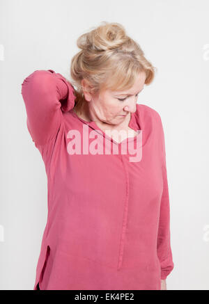 an older blonde woman holding his neck with her hand Stock Photo