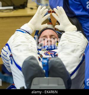 Expedition 43 NASA Astronaut Scott Kelly in his Russian sokol suit waits for his space suit gloves to be put on ahead of his launch onboard the Soyuz TMA-16M spacecraft to the International Space Station March 27, 2015 in Baikonur, Kazakhstan. Kelly and crew mates, Russian Cosmonauts Gennady Padalka, and Mikhail Kornienko will spend a year aboard the ISS. Stock Photo
