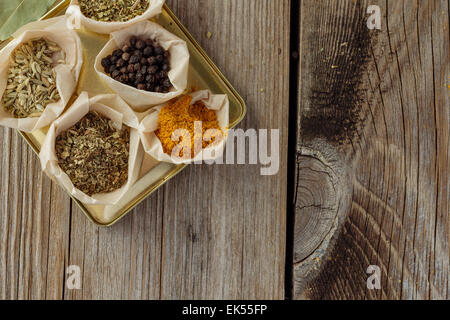 Different herbs and spices on wooden table top view Stock Photo