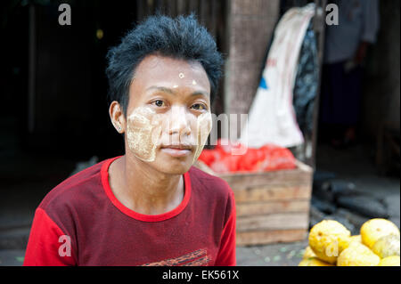 Portrait of a Burmese man face smeared with sandalwood paste at a Yangon street market Myanmar Stock Photo