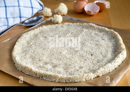 Pizza crust made from cauliflower 'rice' and eggs rather than traditional bread dough. Stock Photo