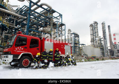 Gulei, China's Fujian Province. 7th Apr, 2015. Firefighters take a rest after putting out a fire caused by a chemical plant blast in Zhangzhou, southeast China's Fujian Province, April 7, 2015. A xylene facility leaked oil and caught fire, which led to blasts and a fire at three nearby oil storage tanks at Tenglong Aromatic Hydrocarbon (Zhangzhou) Co. Ltd. on the Gulei Peninsula in Zhangzhou City at 6:56 p.m. (1056GMT) on Monday. The blaze was put out 21 hours after the blast here which injured six, said local authorities on Tuesday. Credit:  Jiang Kehong/Xinhua/Alamy Live News Stock Photo