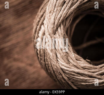 Close up of a ball of string on a wooden table. Stock Photo