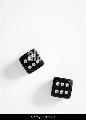 Top view of a pair of black dice on white background with copy space. Double sixes. Stock Photo