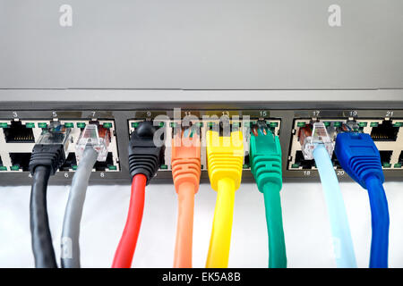 Network Switch with connected colorful network cables Stock Photo
