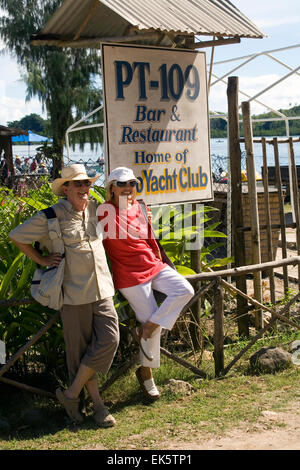 Orion cruise ship passengers pose at the PT-109 Bar & Restaurant, a town of of Gizo landmark on Ghizo Island. Stock Photo