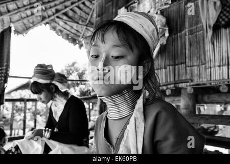 Thailand, Chang Mai, Karen Long Neck hill tribe village (Kayan Lahwi), young girl and her mother in traditional costumes. Women Stock Photo