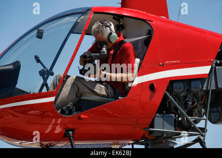 Movie operator filming from a helicopter Stock Photo