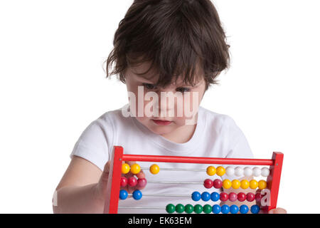 Three year old girl playing with an abacus on white background Stock Photo