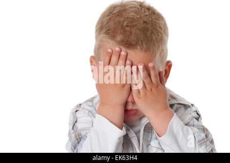 Portrait of a little boy with his hands for his eyes on white background Stock Photo