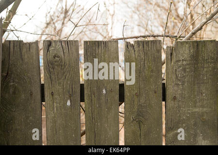 Fragment of old wooden picket fence Stock Photo