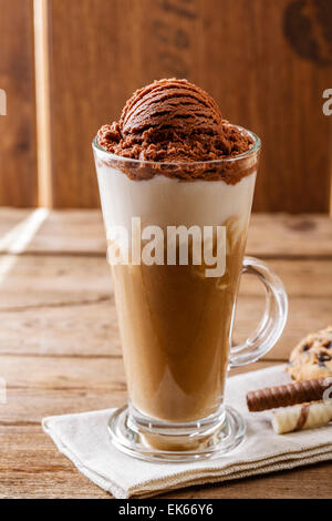 Iced coffee cocktail or frappe with ice cubes and cream in different  glasses with jezva, silver shaker, bottle of rum, coffee beans around on  white ma Stock Photo - Alamy