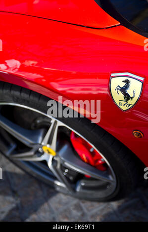 'Prancing Horse' logo on a red Ferrari car Stock Photo
