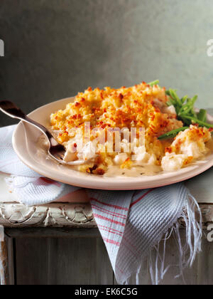 Traditional fish potato pie meal served on a plate in a rustic table setting Stock Photo