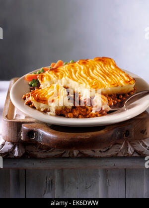 prepared minced Lamb meat Shepherd's Pie recipe served on a plate in a rustic table setting Stock Photo