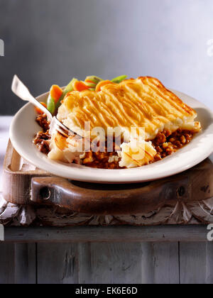 prepared minced Lamb meat Shepherd's Pie recipe served on a plate in a rustic table setting Stock Photo