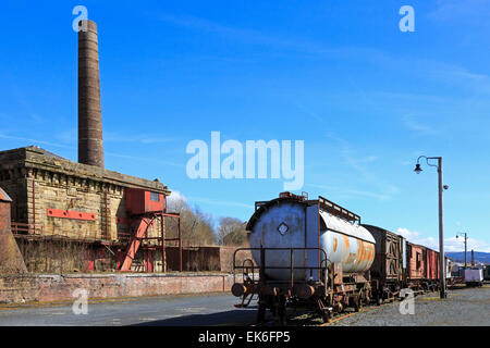 Disused and abandoned factory with old railway carriages nearby, Ayrshire, Scotland, UK Stock Photo